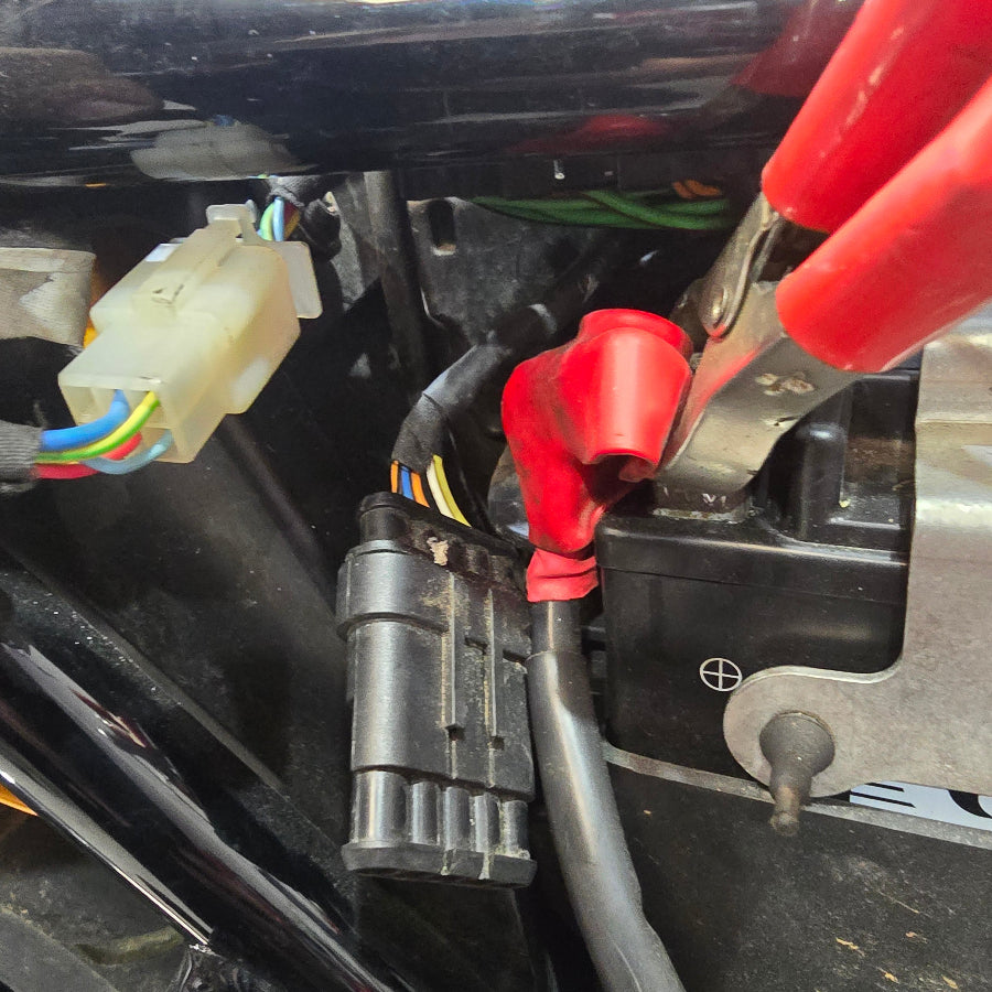 connector  accessed from behind battery